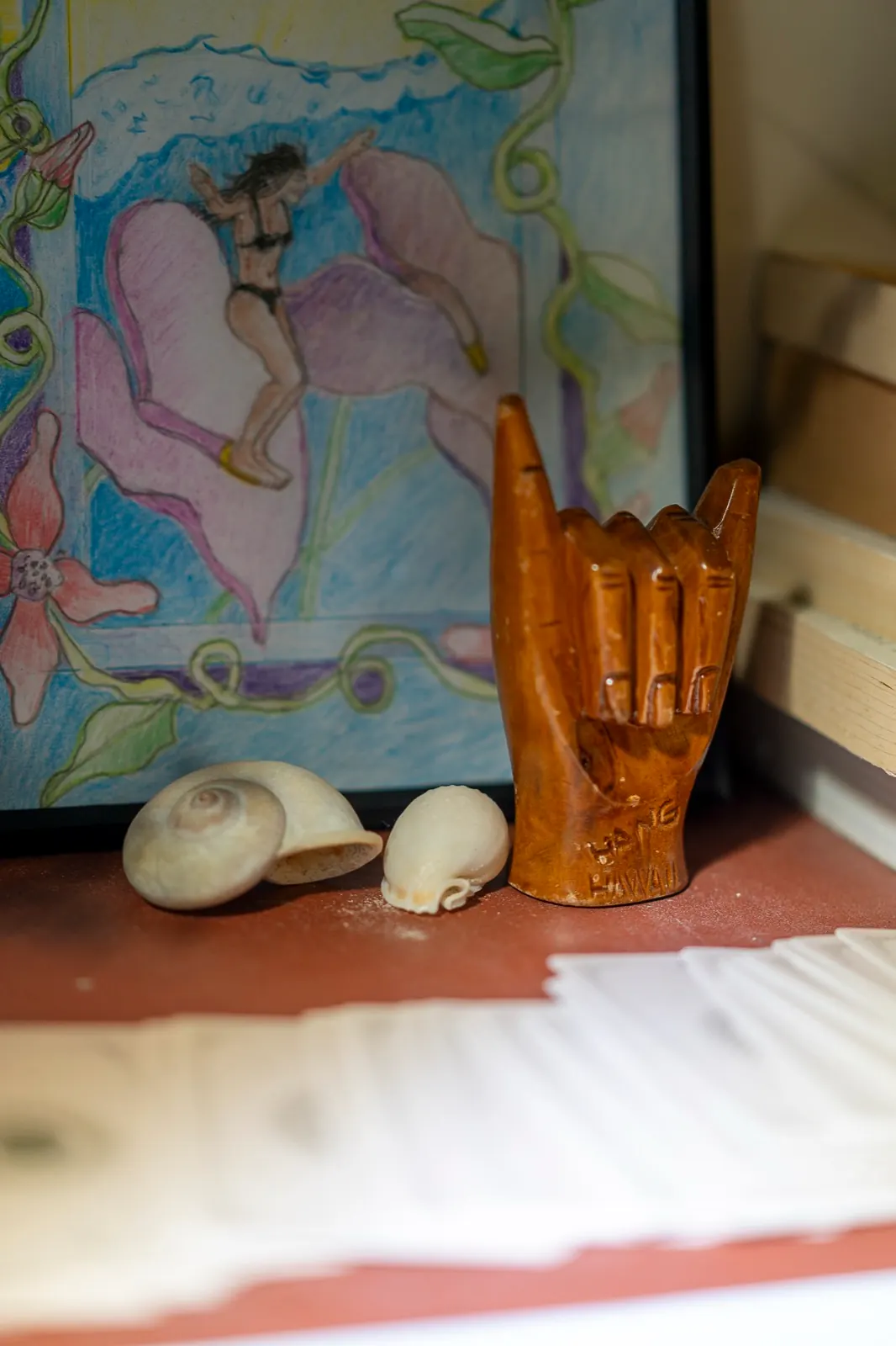 Hand-carved wooden shaka, sea shells, and ocean art in the sanctuary lounge