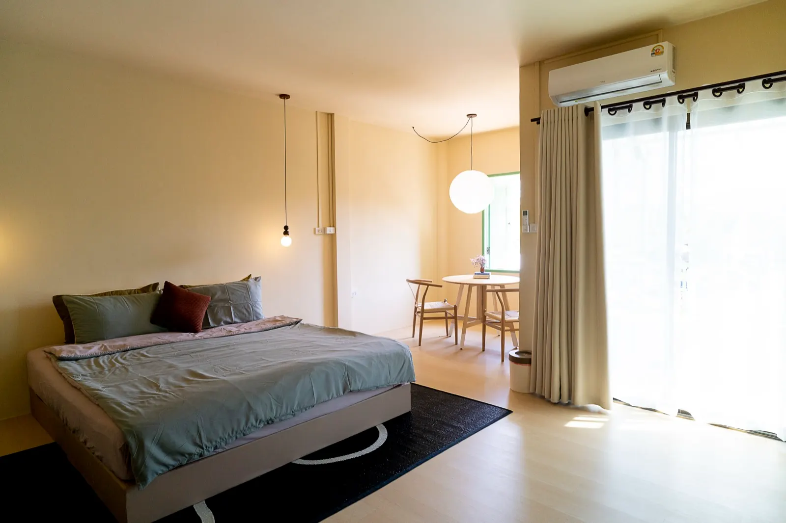 Two-Bedroom Master Apartment at Oceanchild with plush king bed, wishbone dining table, and mountain-view balcony